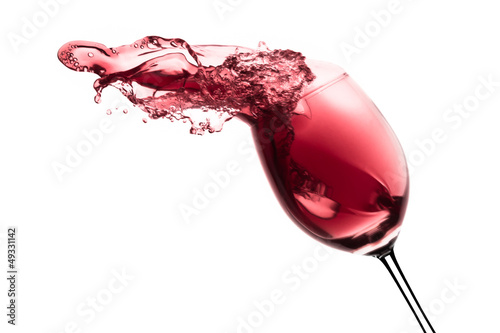 Photo: red wine splashing out of a glass, isolated on white red wine splashing out of a glass, isolated on white