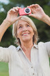 Older woman taking a photo