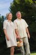 Older couple walking with basket of fruit