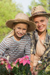 Mother and daughter gardening together portrait