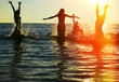 Silhouettes of people jumping in ocean Silhouettes of people jumping in ocean