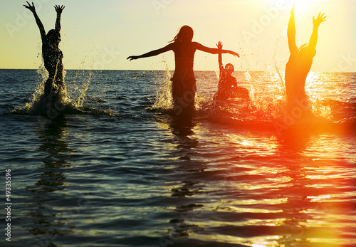 Photo: Silhouettes of people jumping in ocean Silhouettes of people jumping in ocean