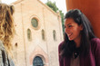 Two girls talking outdoors in S. Stephen square, Bologna, Italy.