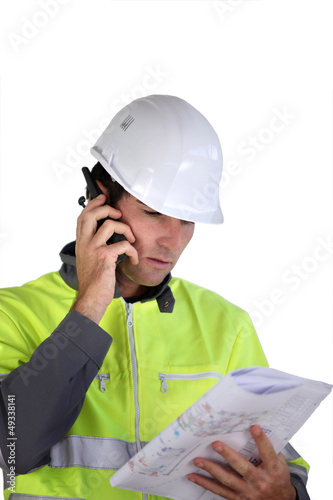 Photo: Worker with a two-way radio Worker with a two-way radio
