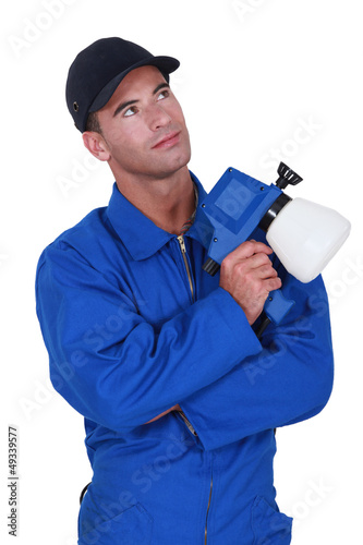Photo: workman in jumpsuit looking upwards workman in jumpsuit looking upwards