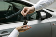 woman receiving car key from man