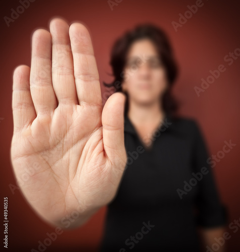 Photo: Woman with her hand extended signaling to stop Woman with her hand extended signaling to stop