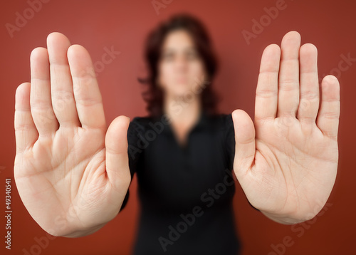 Photo: Woman with her two hands extended signaling to stop Woman with her two hands extended signaling to stop