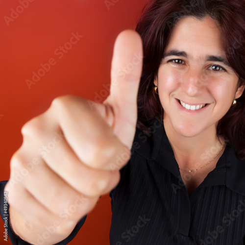 Photo: Beautiful hispanic woman doing the thumbs up sign Beautiful hispanic woman doing the thumbs up sign