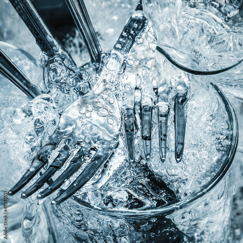 Photo: Cutlery and glasses being washed Cutlery and glasses being washed