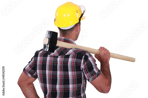 Photo: Man carrying sledge-hammer over shoulder Man carrying sledge-hammer over shoulder