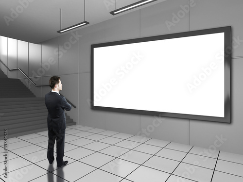 Photo: businessman looking at billboard businessman looking at billboard