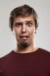 Portrait of young man with scared expression