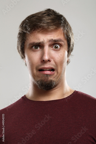 Photo: Portrait of young man with scared expression Portrait of young man with scared expression
