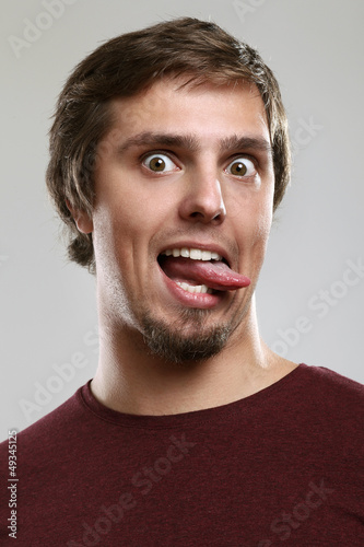 Photo: Portrait of young man with silly grimace Portrait of young man with silly grimace