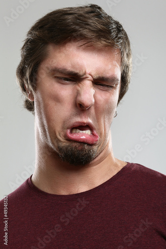 Photo: Portrait of young man with silly grimace Portrait of young man with silly grimace