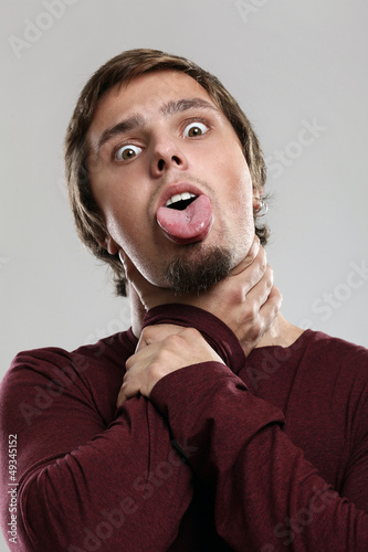 Photo: Young man shows a dead man Young man shows a dead man