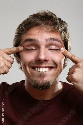 Photo: Portrait of young man with silly grimace Portrait of young man with silly grimace