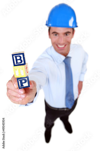 Photo: Architect holding toy building blocks Architect holding toy building blocks