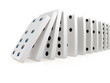 Close up of white dominoes falling over