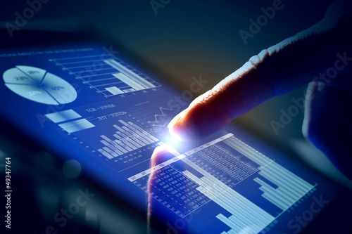 Photo: Closeup of finger touching tablet-pc screen Closeup of finger touching tablet-pc screen