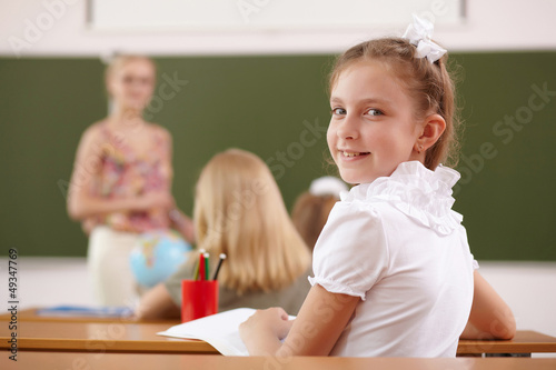 Photo: Little girl at school class Little girl at school class