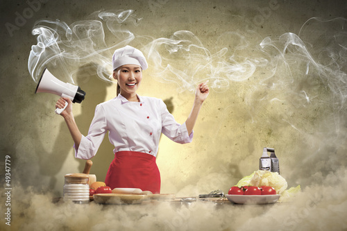 Photo: Asian female cook holding megaphone Asian female cook holding megaphone