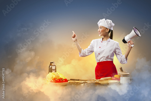 Photo: Asian female cook holding megaphone Asian female cook holding megaphone