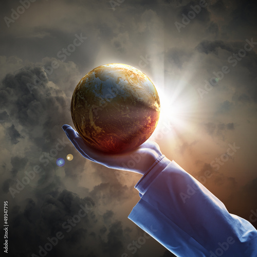Photo: Image of earth planet on hand Image of earth planet on hand