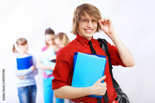Photo: Student in red shirt with books Student in red shirt with books