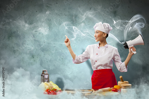 Photo: Asian female cook holding megaphone Asian female cook holding megaphone