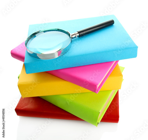 Photo: color books with magnifying glass isolated on white color books with magnifying glass isolated on white