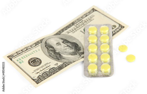 Photo: Pills and money isolated on white Pills and money isolated on white