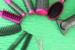 Comb brushes, hairdryer and cutting shears,on color background
