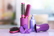 Hair brushes, hairdryer and cosmetic bottle in beauty salon.