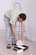 Decorator pouring paint into a tray