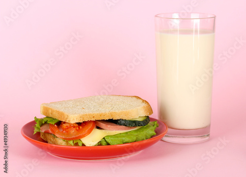 Photo: Sandwich on plate with milk on pink background Sandwich on plate with milk on pink background