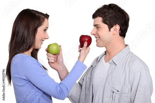 Photo: Couple exchanging apples Couple exchanging apples