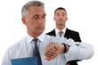 handsome businessman checking his watch