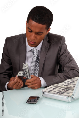 Photo: Man counting bank notes Man counting bank notes