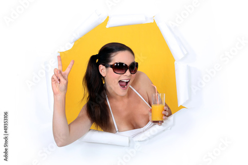 Photo: Woman coming out of hole with orange juice Woman coming out of hole with orange juice