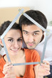couple with meter forming a house