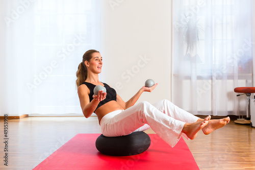 Photo: woman practicing poses on exercise ball woman practicing poses on exercise ball