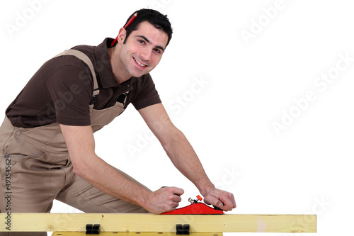 Photo: Man with a sander and a pen Man with a sander and a pen