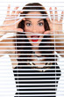 Woman peeking through blinds