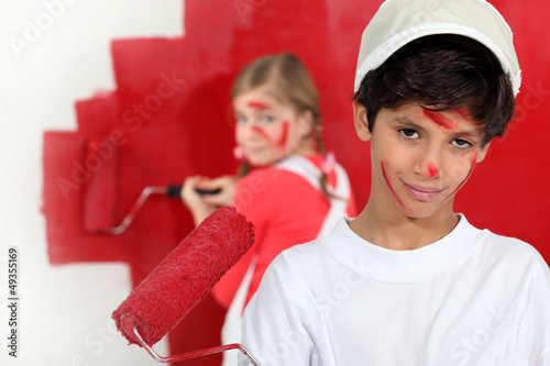 Photo: Children painting a room red Children painting a room red