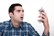 Shocked man with an alarm clock