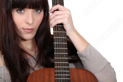 Photo: Brunette holding acoustic guitar Brunette holding acoustic guitar
