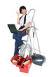 Photo: Female electrician with a laptop Female electrician with a laptop