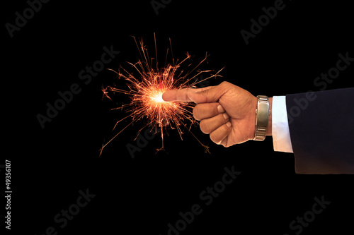 Photo: hand of business man pointing on sparking fire hand of business man pointing on sparking fire